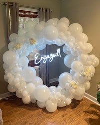 a white balloon ring with the word engaged on it