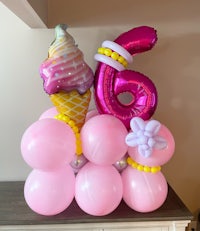 a balloon arrangement with balloons and an ice cream cone