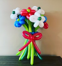 a bouquet of colorful balloons with a bow