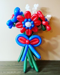 a bouquet of balloons with red, white and blue flowers